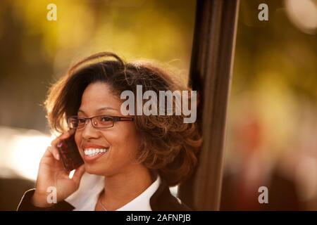 Donna che parla su cellulare all'esterno. Foto Stock