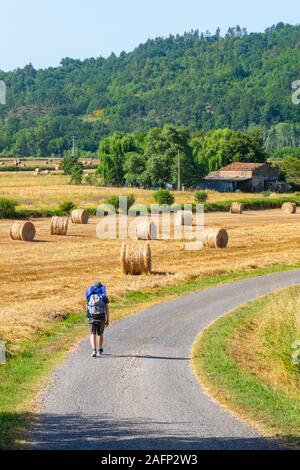 Un solitario camminatore con zaino nella campagna toscana Foto Stock