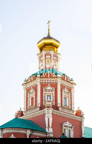 Epifania Chiesa di Mosca. Chiesa ortodossa tradizionale in mattoni rossi, una cupola dorata su uno sfondo luminoso cielo chiaro Foto Stock