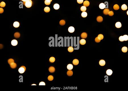Abstract sfondo con golden glitter luce bokeh isolati su sfondo nero. Esso può essere utilizzato come overlay design. Foto Stock