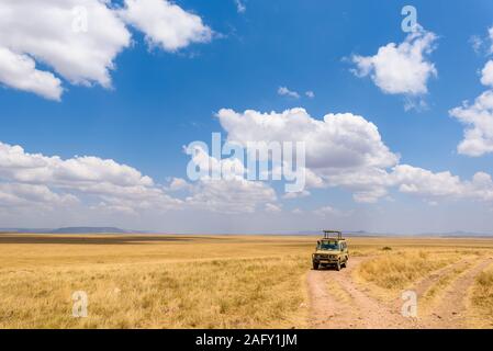 Safari turisti su game drive con Jeep auto nel Parco Nazionale del Serengeti nel bellissimo paesaggio paesaggio, Tanzania, Africa Foto Stock