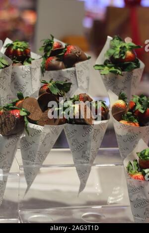 Colpo verticale di fragole ricoperte di cioccolato in coni di carta presi A Las Vegas Foto Stock