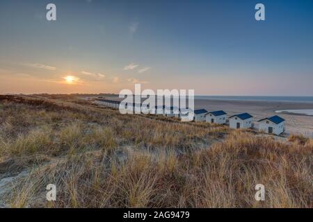 Foto ad alto angolo di cottage simili con tetti blu sulla riva a Vrouwenpolder, Paesi Bassi Foto Stock