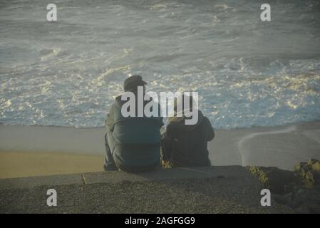 Giovane seduto accanto all'oceano nel sud-ovest della Francia, pasakdek Foto Stock