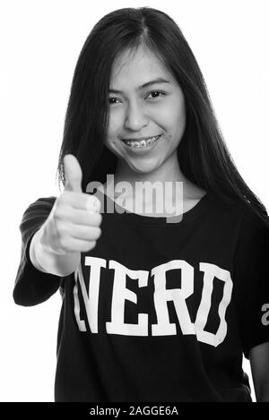 Studio shot di giovani felici Asian teenage nerd ragazza sorridente e dando pollice in alto Foto Stock