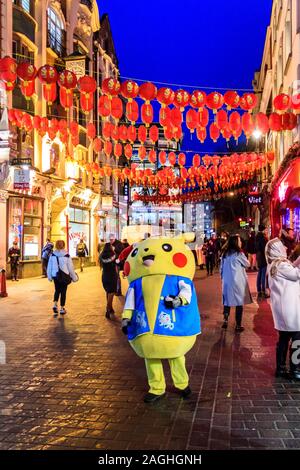 Una persona in un Pikachu Pokemon costume in Chinatown, Wardour Street, Londra, Regno Unito Foto Stock