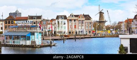 Leiden, Paesi Bassi - 7 Aprile 2016: Panorama con case olandesi tradizionali, porto di canal e mulino a vento in Olanda Foto Stock