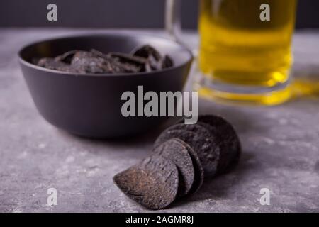 Mais messicano chips nachos e bicchiere di birra. Chip nero nachos per uomini brutali Foto Stock