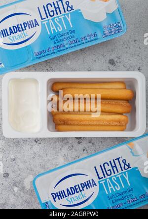 LONDON, Regno Unito - 20 dicembre 2019: Philadelphia snack con formaggio morbido tuffo e grissini sul tavolo luminoso dello sfondo. Foto Stock