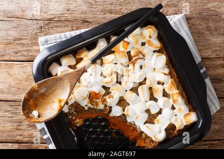 Gustosa patata dolce casseruola con dadi e rabboccato con marshmallows close-up in una teglia sul tavolo. Parte superiore orizzontale vista da sopra Foto Stock