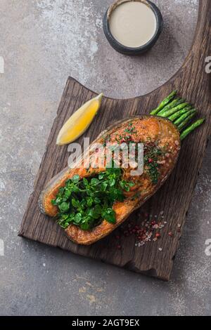 Fritto bistecca di salmone con asparagi su tavola di legno, spazio di copia Foto Stock