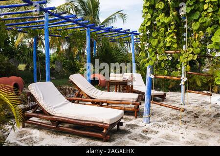 le sedie da letto di bambù, il piccolo tavolo sono sotto il tetto di legno blu in giardino Foto Stock