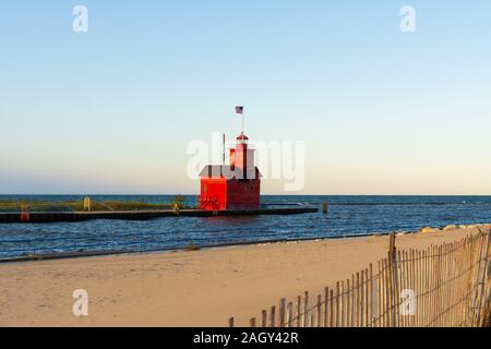 Grande faro rosso come il sole sorge su una bella mattina di autunno. Holland, Michigan, Stati Uniti d'America Foto Stock
