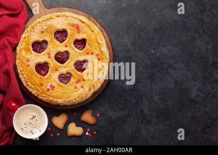 Lampone torta per il giorno di San Valentino con il cuore e la tazza di caffè. Vista da sopra con lo spazio per i messaggi di saluto Foto Stock