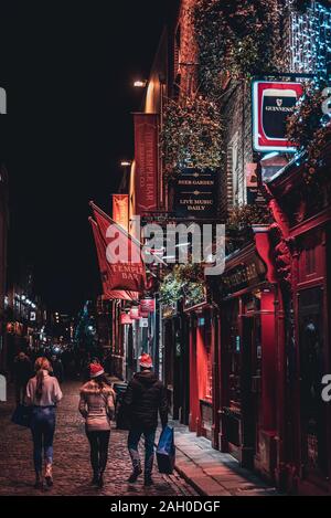 Dublino, Irlanda, dicembre 24, 2018: la gente camminare in Temple Bar storico quartiere,un quartiere culturale con la vivace vita notturna. Notturni della barra Foto Stock