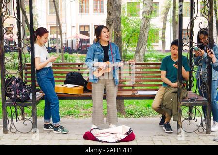 BISHKEK, REPUBBLICA DEL KIRGHIZISTAN - Aprile 14, 2018: giovane donna asiatica con chitarra classica per la riproduzione di musica Foto Stock