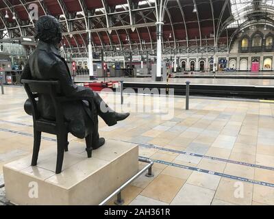 Una statua di Isambard Kingdom Brunel si affaccia sulla stazione Paddington di Londra che è vuota di treni alla vigilia di Natale a causa di importanti lavori di ingegneria informatica oltre il periodo della vacanza sulla linea ferroviaria tra le stazione di Paddington e di Slough. Foto Stock