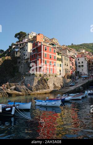 Il colorfully case dipinte e piccole imbarcazioni nel villaggio di pescatori del porto di Riomaggiore Parco Nazionale delle Cinque Terre Liguria Italia EU Foto Stock