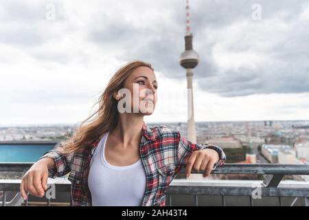 La donna in una terrazza di osservazione con la torre della televisione in background, Berlino, Germania Foto Stock