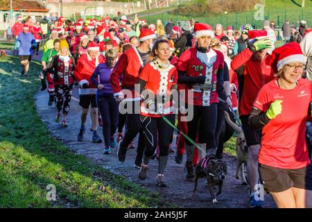 Chippenham, Wiltshire, Regno Unito. 25th dicembre 2019. I corridori in vestito di fantasia sono ritratti mentre prendono parte ad un parkrun 5km di Natale di mattina presto in Monkton Park, Chippenham, Wiltshire. 400-500 persone hanno partecipato all'evento con molti vestirsi in abito elegante. Credito: Lynchpics/Alamy Live News Foto Stock