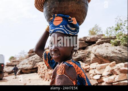 MALI, Bandiagara, Dogonland, habitat dell'etnia Dogon, ragazza equilibrio calabash sulla testa Foto Stock