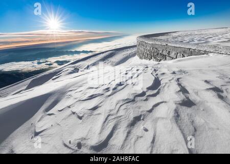 Ampia vista panoramica del paesaggio montano innevato all'alba Foto Stock