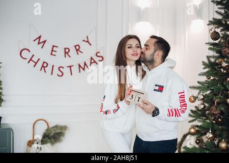 La Bielorussia Minsk 16 12 2019:Coppia felice kissing godendo Xmas vacanza insieme con emozione positiva Foto Stock