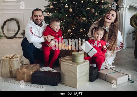 La Bielorussia Minsk 16 12 2019:felice vacanza famiglia i genitori e il bambino divertirsi in posa ad albero di Natale sfondo Foto Stock