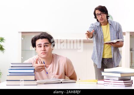 Il maschio di due studenti in preparazione per gli esami a casa Foto Stock