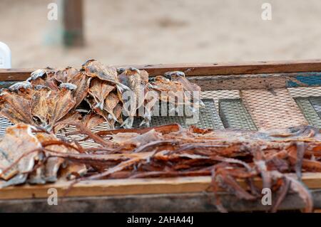 Al fine di preservare il pesce i pescatori portoghesi asciugare il pesce al sole sulla spiaggia. Fotografato a Nazare, Portogallo Foto Stock