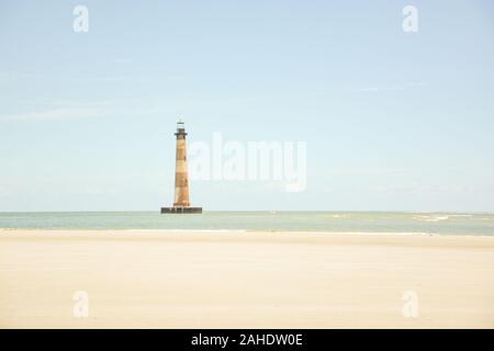 L'iconico faro, ora sul Registro Nazionale dei Luoghi Storici, sorge sopra il mare su Morris island vicino a Charleston, Carolina del Sud. Foto Stock