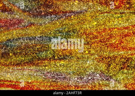 Abstract background testurizzata di oro e arancione glitter volute Foto Stock