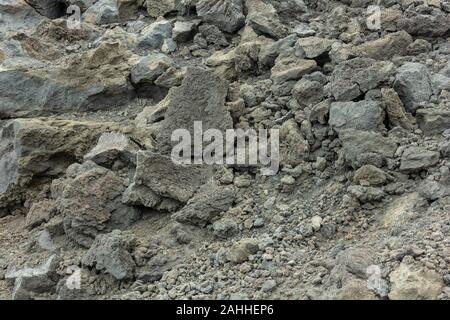 Sfondo di pietre sul terreno nero della lava di un vulcano Etna Foto Stock