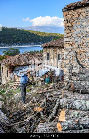 La trinciatura di legna da ardere per l'inverno nel piccolo villaggio di pescatori di Psarades sul lago Prespa in Macedonia, Grecia settentrionale. Foto Stock