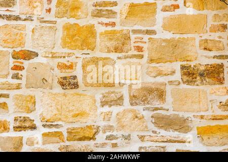 Antica pietra di parete di mattoni texture pattern di sfondo. Vecchio muro di antica architettura. Sullo sfondo di un antico muro di pietra. Texture di mattoni vecchi. Architettura romana. Il vecchio muro fatto di pietra di Gerusalemme Foto Stock