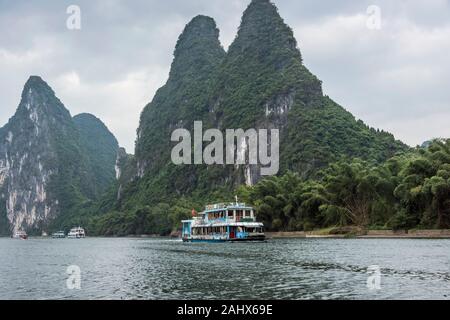 Tour in barca navigando tra le montagne carsiche sul fiume li, Xingping, Guangxi, Cina Foto Stock