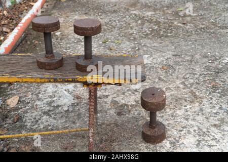 Vecchio arrugginito DIY dumbbell costituita da ferro presso il parco pubblico Foto Stock