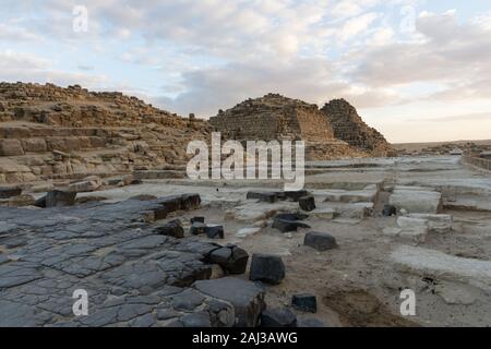 Nero basalto blocchi e tre piccole piramidi vicino a piramide di Khufu (o la piramide di Cheope) Foto Stock