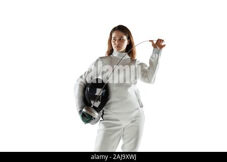 Campione. Teen ragazza in costume di scherma con la spada in mano isolati su sfondo bianco. Giovani modello femminile con la pratica e la formazione in movimento, l'azione. Copyspace. Sport, gioventù, uno stile di vita sano. Foto Stock