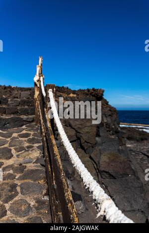 Weathered corda corrimano sui passi sopra la roccia vulcanica a Playa de Sibora, Los Silos, Tenerife, Isole Canarie, Spagna Foto Stock