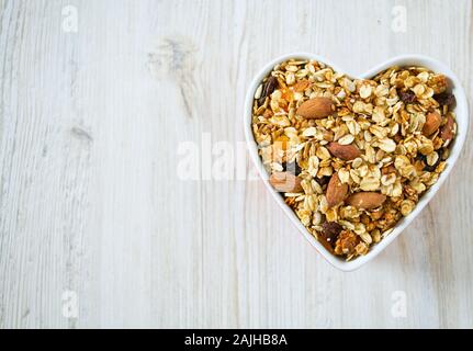 Granola in un cuore-ciotola sagomata Foto Stock