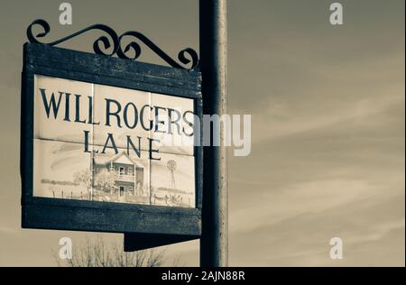 Close up di piastrelle pittorico raffigurante Garrett house incorniciato in un raffinato Cartello in metallo titolare la lettura di Will Rogers Lane, contro un cielo blu in Tubac, AZ Foto Stock