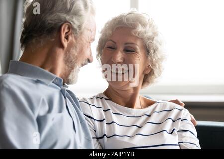 Anziani allegro nonna ridere avente una piacevole conversazione con il nonno Foto Stock