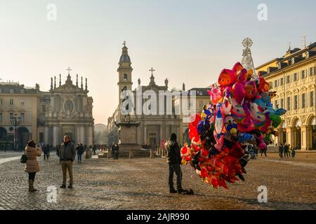 Vista della piazza San Carlo piazza nel centro storico di Torino con un palloncino e il venditore e i turisti durante le vacanze di Natale, Piemonte, Italia Foto Stock