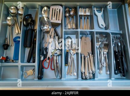 Una grande casa interno cucina cassetto riempita con una collezione di utensili da cucina e posate Foto Stock