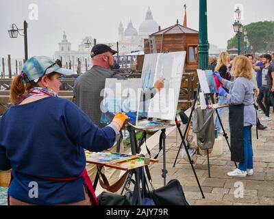 La pittura di artisti in Piazza San Marco a Venezia, Italia, in una nebbiosa, nuvoloso giorno Foto Stock