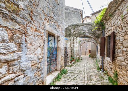 Tipico acciottolato stretto vicoletto con archi di pietra nel centro storico della cittadina nella balla, una piccola cittadina collinare sul Mont Pélerin in Istria, Croazia Foto Stock