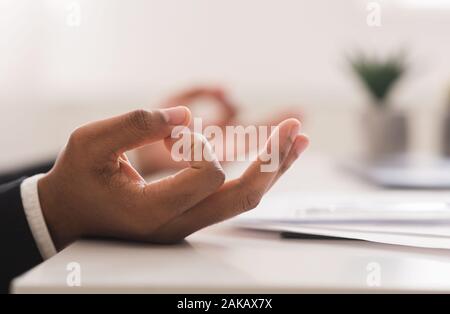 Ravvicinata di un imprenditore nero mani meditando a workplace, concetto di burnout Foto Stock