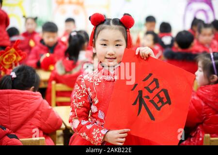 Jiangsu, Jiangsu, Cina. Gen 8, 2020. Jiangsu, Cina-lingua straniera kindergarten di Rugao città, provincia dello Jiangsu, 7 gennaio 2020, per sperimentare la cultura tradizionale festival.I bambini in rosso cappotto sotto la guida di insegnanti e genitori per rendere lanterne rosse, nodo Cinese e altre nuove Anno decorazioni, inviare benedizioni per gli insegnanti e gli studenti, felice di dare il benvenuto al nuovo anno festival. Credito: SIPA Asia/ZUMA filo/Alamy Live News Foto Stock