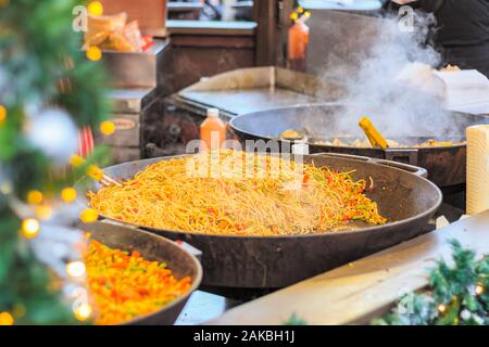 Agitare cinese noodles fritti in esposizione al mercato di Natale in winter wonderland di Londra Foto Stock